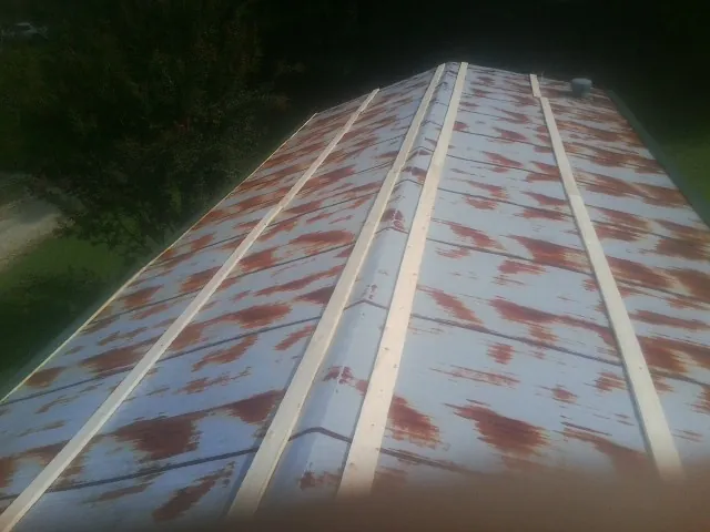 Rusted metal roof panels with new wood purlins before replacement — Storm Damage Roof Repair in Jersey City by Roofing Brothers